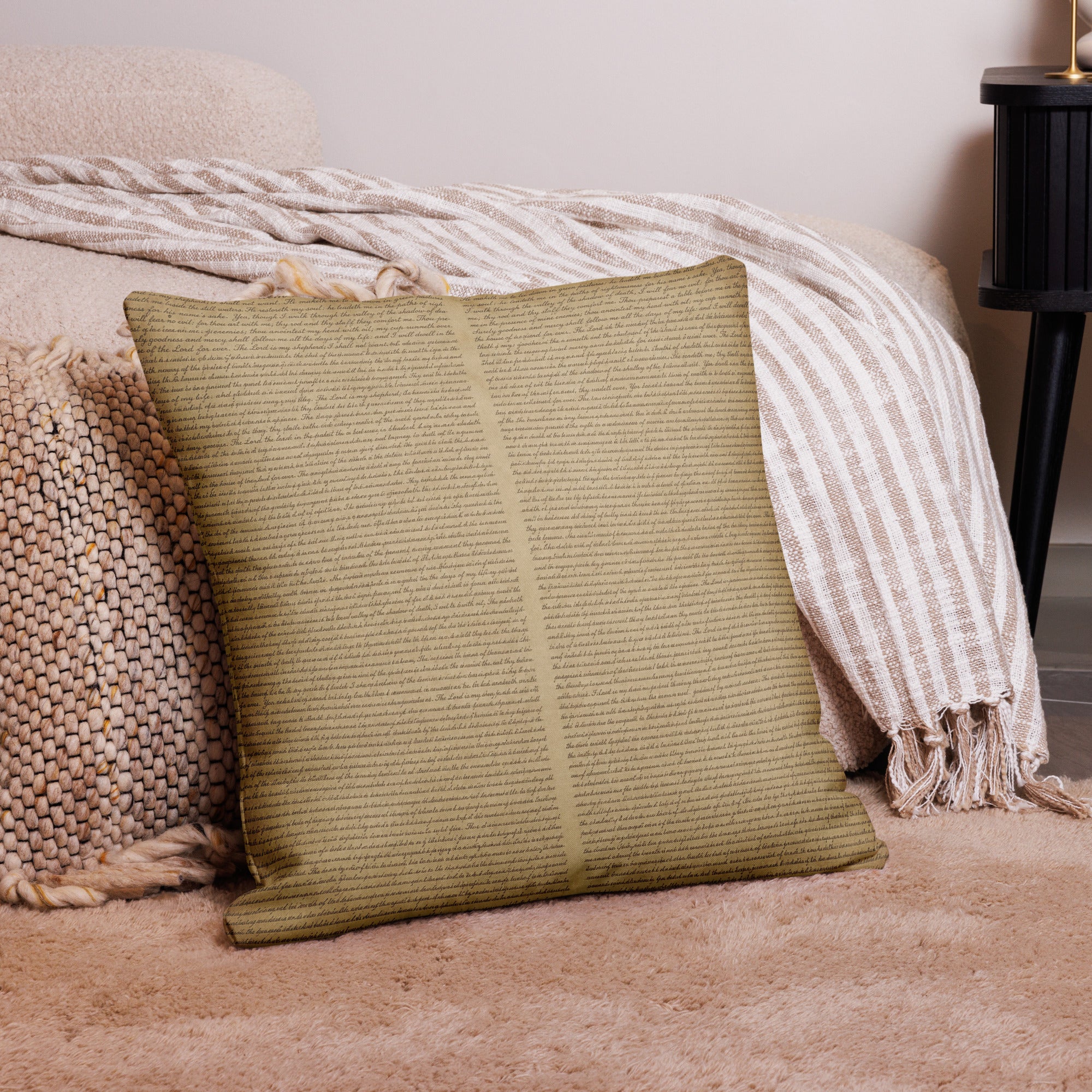 Luxury Comfort Pillow with a subtle script pattern in warm beige tones, styled on a cozy textured woven cushion and soft striped throw in an elegant home setting.