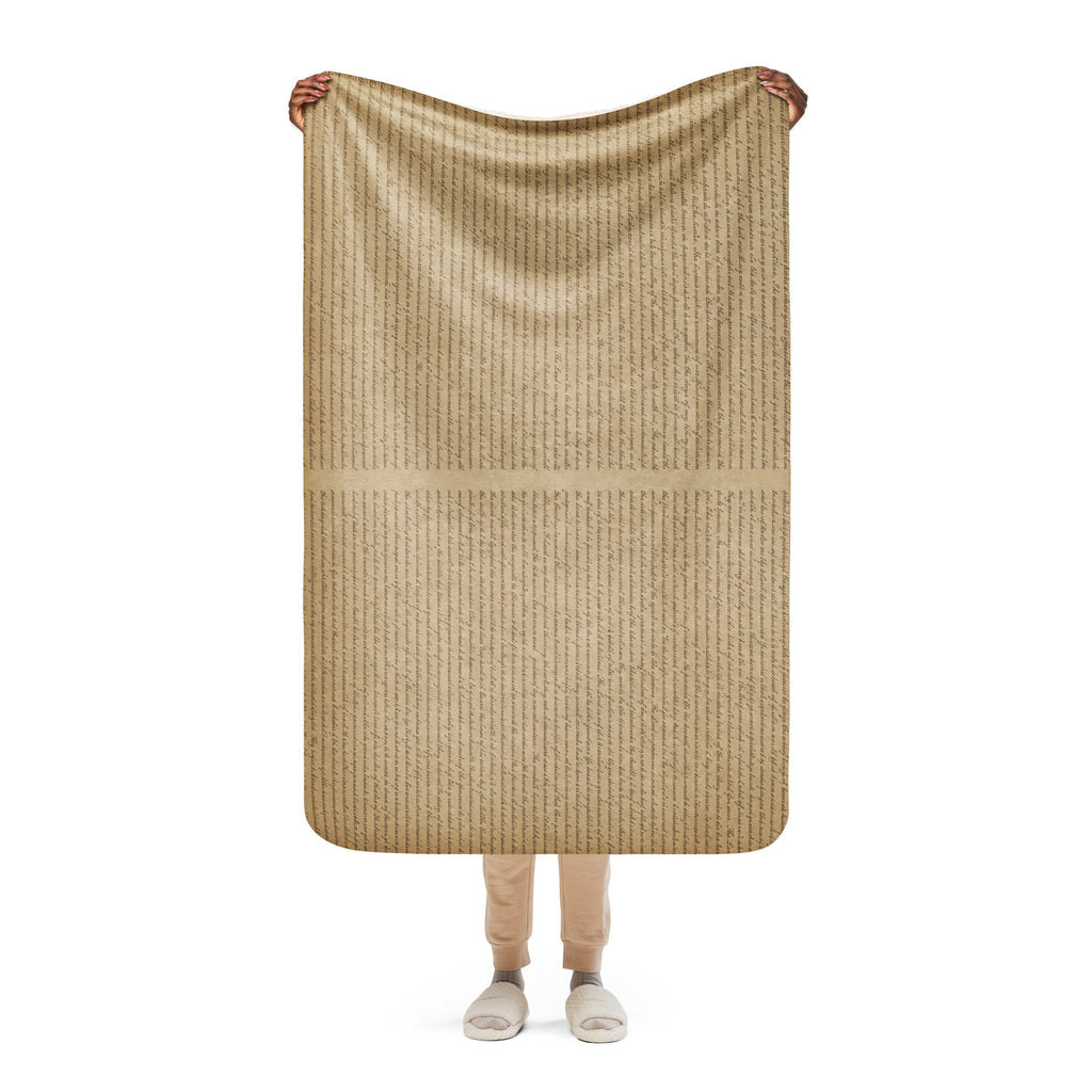 Person holding a tan Luxury Sherpa Throw Blanket featuring a subtle striped texture, showcasing its soft and cozy fabric ideal for premium home decor.