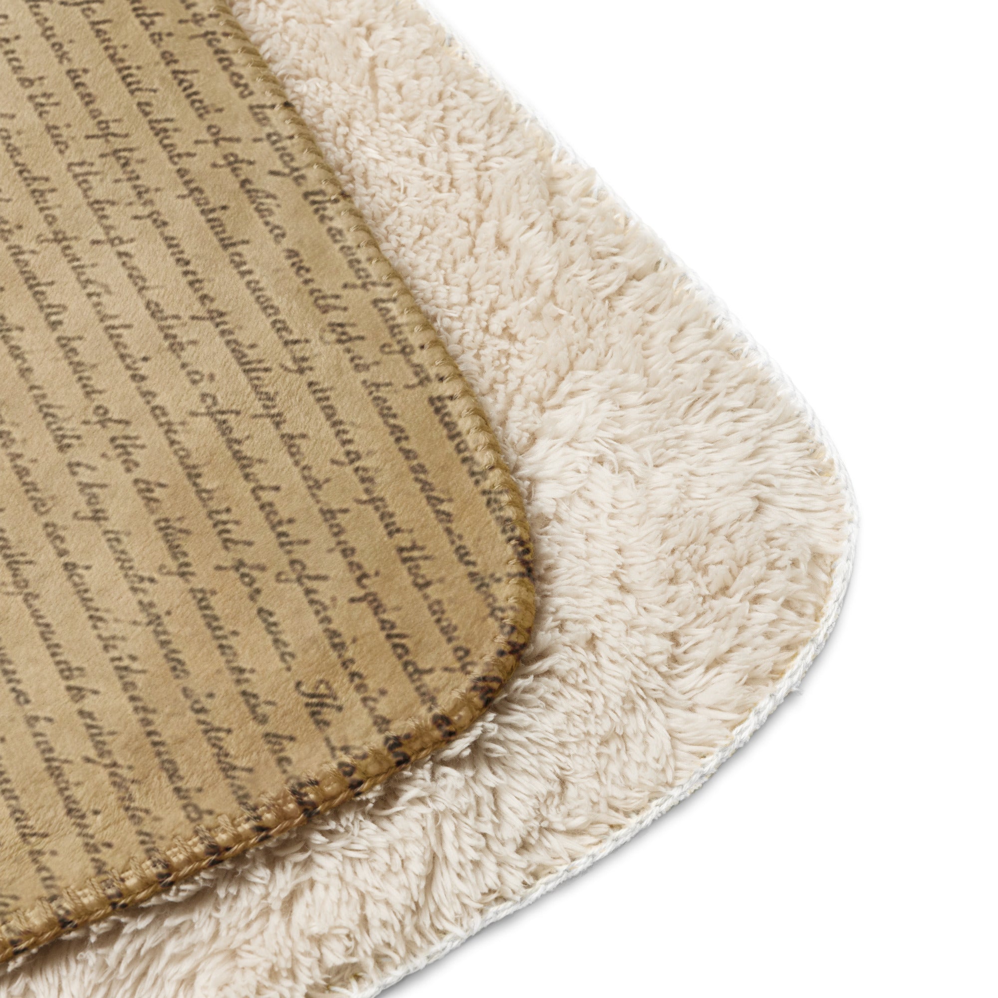 Close-up of a tan Luxury Sherpa Throw Blanket showing a soft, plush sherpa side and a smooth side with cursive script pattern, highlighting its premium, elegant texture.